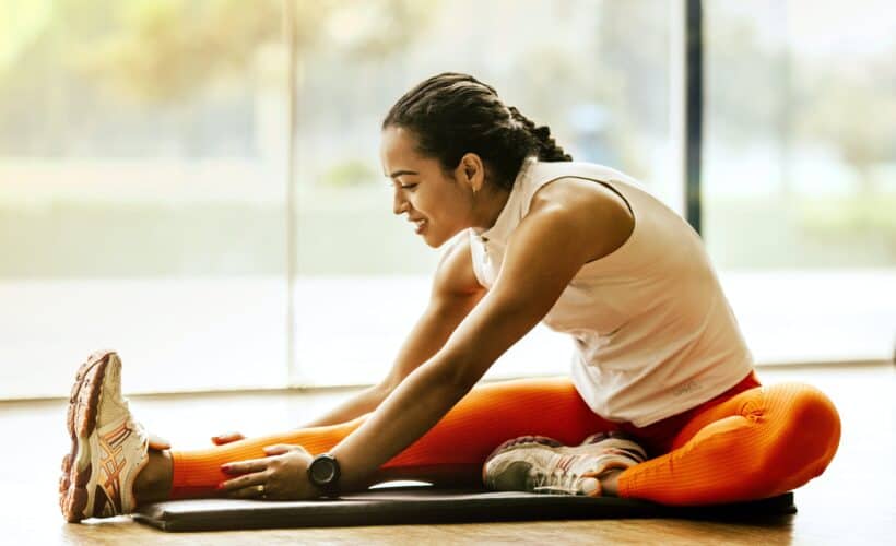 woman stretching on ground