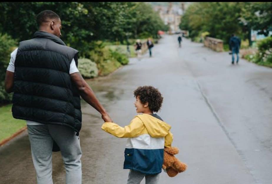 A father and his son are taking a walk in the park