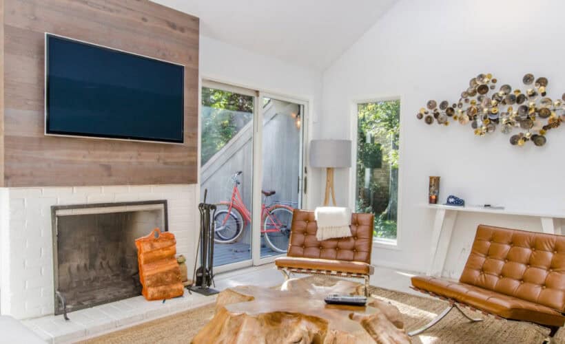 two tufted brown leather chairs in front of brown wood stump center table